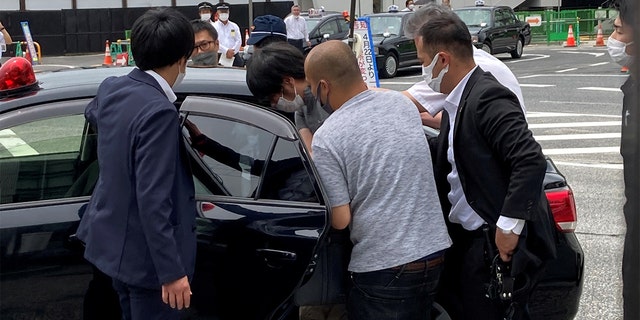 Tetsuya Yamagami is seen being taken into custody.
