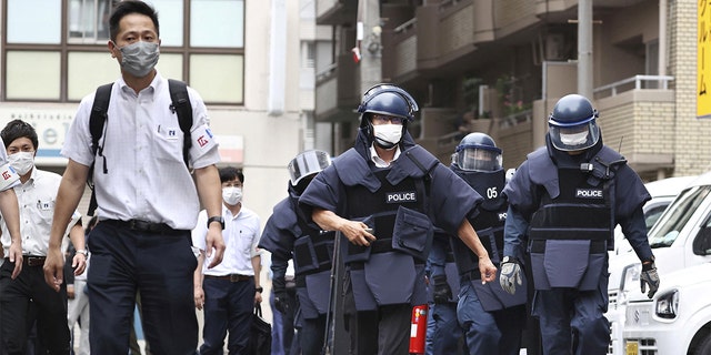 In this photo taken by Kyodo News, police investigators arrive at the suspect's residence, which is believed to have shot former Prime Minister Shinzo Abe in Nara on July 8, 2022. 