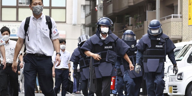 Police investigators arrive at the residence of the suspect who was believed to have shot former Japanese Prime Minister Shinzo Abe, in Nara, Japan July 8, 2022 in this photo taken by Kyodo.
