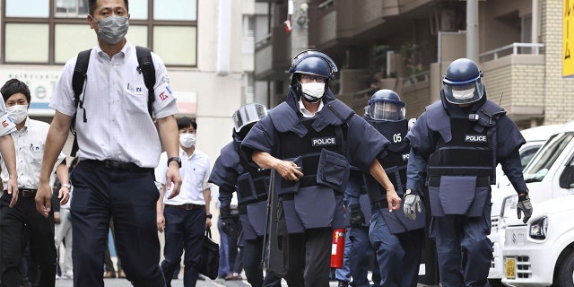 In this photo taken by Kyodo News, police investigators arrive at the suspect's residence, which is believed to have shot former Prime Minister Shinzo Abe in Nara on July 8, 2022. 