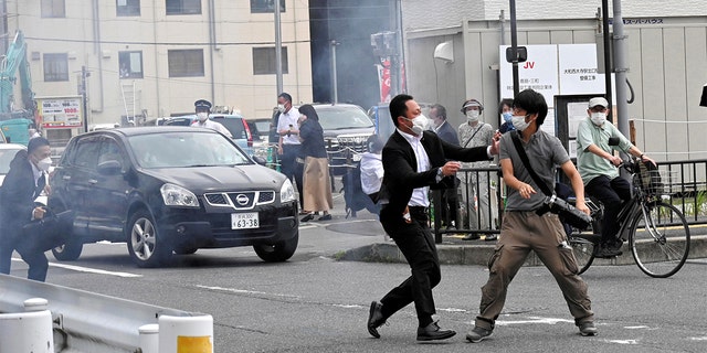 A police officer detains a man, believed to have shot former Japanese Prime Minister Shinzo Abe, in Nara, western Japan July 8, 2022 in this photo taken by The Asahi Shimbun. 