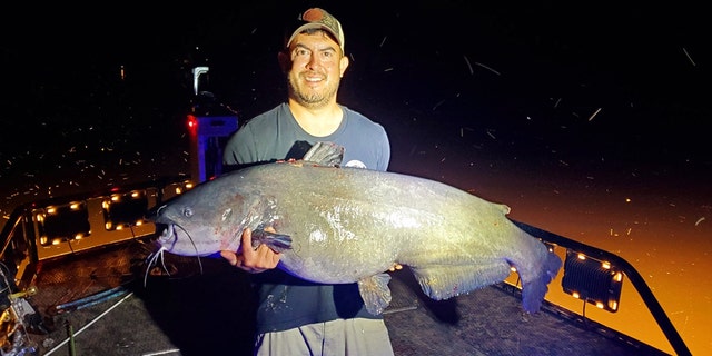 Jason Emmel caught a 66-pound, 5-ounce blue catfish with a bow and arrow in Virginia's Pamunkey River on Monday. 