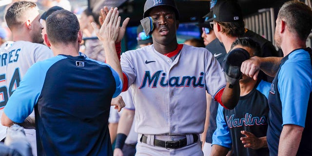 Miami Marlins' Jesus Sanchez celebrates after scoring off an RBI-single by Luke Williams during the tenth inning of a baseball game against the New York Mets, Sunday, July 10, 2022, in New York.
