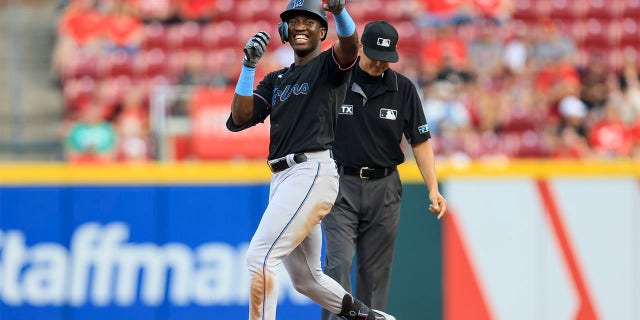 Miami Marlins' Jesus Sanchez smiles as he gestures to the dugout after hitting a double during the fifth inning of a baseball game against the Cincinnati Reds in Cincinnati, Tuesday, July 26, 2022.