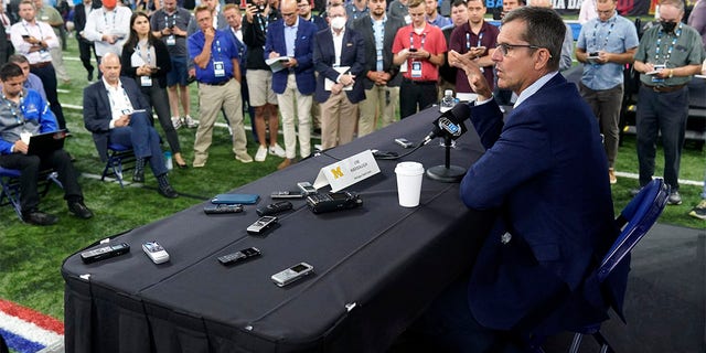 Michigan head coach Jim Harbaugh talks to reporters during an NCAA college football news conference at the Big Ten Conference media days, at Lucas Oil Stadium, Tuesday, July 26, 2022, in Indianapolis. 