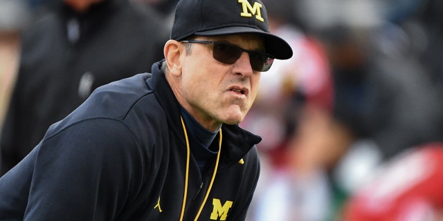 Michigan Wolverines head coach Jim Harbaugh looks on during pre-game warm-ups before an NCAA college football game against the Maryland Terrapins.
