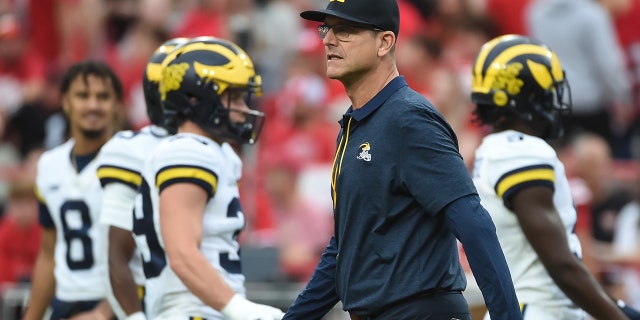 Head coach Jim Harbaugh of the Michigan Wolverines walks the field before the game against the Nebraska Cornhuskers at Memorial Stadium on October 9, 2021 in Lincoln, Nebraska.