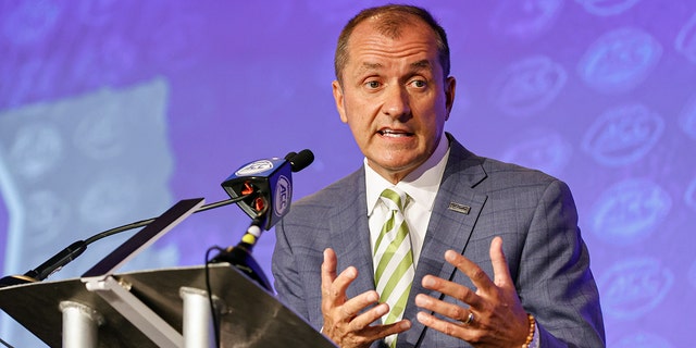 Atlantic Coast Conference commissioner Jim Phillips answers a question during an NCAA college football news conference at the ACC media days in Charlotte, N.C., Wednesday, July 20, 2022.