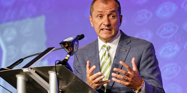 Atlantic Coast Conference commissioner Jim Phillips answers a question during an NCAA college football news conference at the ACC media days in Charlotte, N.C., Wednesday, July 20, 2022.