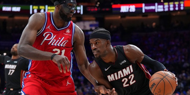 No. 22 Jimmy Butler of the Miami Heat hits the basket against No. 21 Joel Embiid of the Philadelphia 76ers during Game 4 of the 2022 NBA Eastern Conference Playoff Semifinals at the Wells Fargo Center on May 8, 2022 in Philadelphia, Pennsylvania.  The 76ers defeated the Heat 116-108.