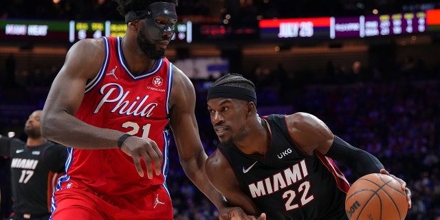Jimmy Butler #22 of the Miami Heat drives to the basket against Joel Embiid #21 of the Philadelphia 76ers during Game Four of the 2022 NBA Playoffs Eastern Conference Semifinals at the Wells Fargo Center on May 8, 2022 in Philadelphia, Pennsylvania. The 76ers defeated the Heat 116-108.