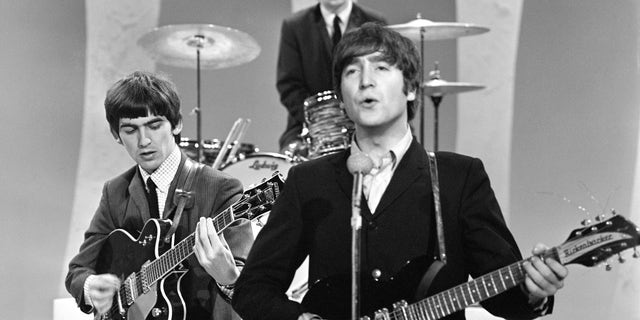 John Lennon performed his prized 1958 Rickenbacker 325 when the Beatles first performed "The Ed Sullivan Show' on Sunday, Feb. 9, 1964, from CBS's Studio 50 in New York City. Three of the four band members are shown here (from left): George Harrison, Ringo Starr (drummer) and John Lennon. 