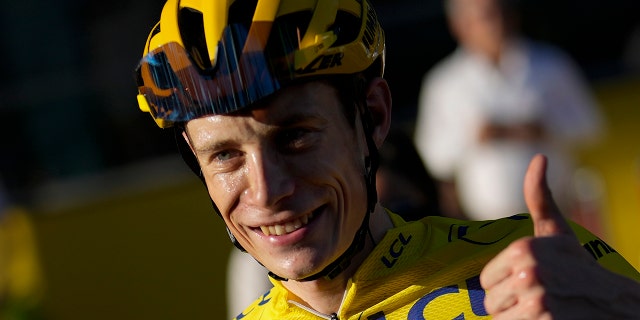 Tour de France winner Denmark's Jonas Vingegaard, wearing the overall leader's yellow jersey, flashes a thumbs up after the twenty-first stage of the Tour de France cycling race over 116 kilometers (72 miles) with start in Paris la Defense Arena and finish on the Champs Elysees in Paris, France, Sunday, July 24, 2022.