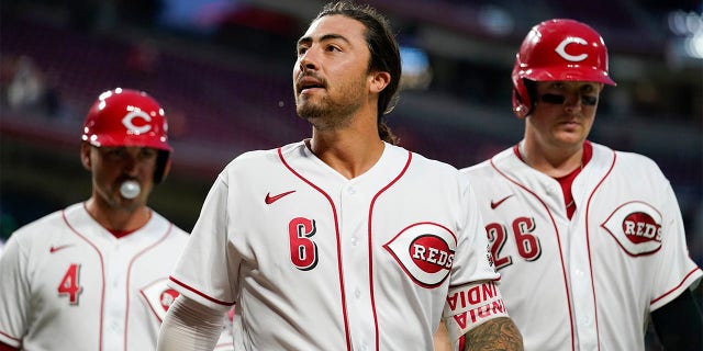 Cincinnati Reds' Jonathan India (6) walks off the field with Matt Reynolds (4) and Michael Papierski (26) after hitting a grand slam during the fifth inning of a baseball game against the Miami Marlins, Monday, July 25, 2022, in Cincinnati.