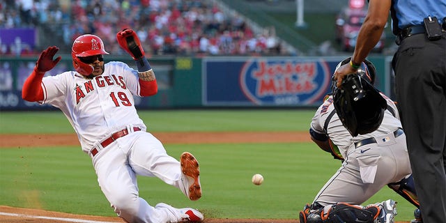 Los Angeles Angels' Jonathan Villar, left, scores on a single by Brandon Marsh as Houston Astros catcher Martin Maldonado takes a late throw during the second inning of a baseball game Wednesday, July 13, 2022, in Anaheim, Calif. 