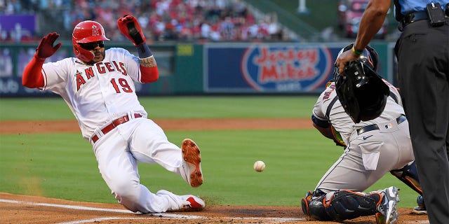 Los Angeles Angels' Jonathan Villar, left, scores on a single by Brandon Marsh as Houston Astros catcher Martin Maldonado takes a late throw during the second inning of a baseball game Wednesday, July 13, 2022, in Anaheim, Calif.
