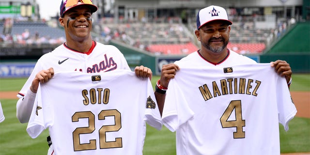 Washington Nationals right fielder Juan Soto (22) and manager Dave Martinez (4) pose with their All-Star jerseys before a baseball game against the Atlanta Braves, Sunday, July 17, 2022, in Washington.