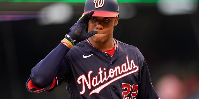 Washington Nationals' Juan Soto gestures to the visiting dugout as he approaches the batter's box for his first at-bat in the first inning of a baseball game against the St. Louis Cardinals, Friday, July 29, 2022, in Washington, D.C.