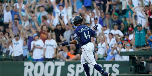 Seattle Mariners' Julio Rodriguez reacts as he rounds the bases after hitting a solo home run against the Texas Rangers during the first inning of a baseball game, Tuesday, July 26, 2022, in Seattle.
