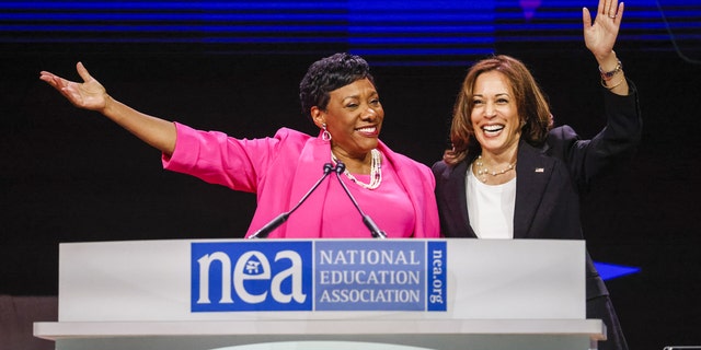 Vice President Kamala Harris, right, waves with Becky Pringle, president of the National Education Association, at the National Education Association 2022 annual meeting and representative assembly in Chicago, Illinois, on Tuesday, July 5, 2022. Harris highlighted educators role in communities across the country and the administration's investments to support students and educators, according to the White House. Photographer: Tannen Maury/EPA/Bloomberg via Getty Images 