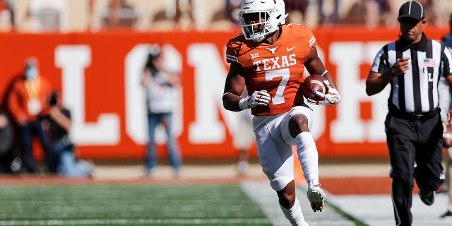 Keilan Robinson #7 of the Texas Longhorns runs the ball in the first half against the Oklahoma State Cowboys at Darrell K Royal-Texas Memorial Stadium on October 16, 2021 in Austin, Texas.
