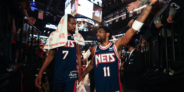 Kevin Durant and Kyrie Irving walk off the court after the Cleveland Cavaliers game on April 8, 2022, at Barclays Center in Brooklyn.