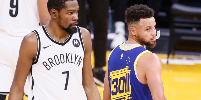 Golden State Warriors guard Stephen Curry (30) and Brooklyn Nets forward Kevin Durant (7) in the first quarter of an NBA game at Chase Center, Saturday, Feb. 13, 2021, in San Francisco, Calif. 