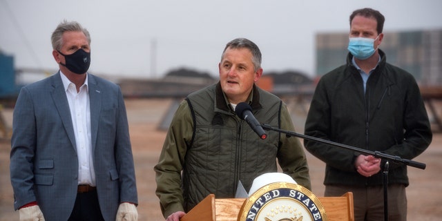 House Minority Leader Kevin McCarthy of Calif., left, and Rep. August Pfluger, R-Texas, right, listen as Rep. Bruce Westerman, R-Ark., talks to the media following a tour of a Diamondback Energy oil rig Feb. 10, 2021, in Midland, Texas.