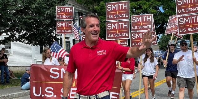 Republican Senate candidate Kevin Smith marches in the annual Amherst, New Hampshire Independence Day parade, on July 4, 2022.