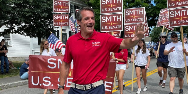 Republican Senate candidate Kevin Smith marches in the annual Amherst, New Hampshire Independence Day parade, on July 4, 2022.