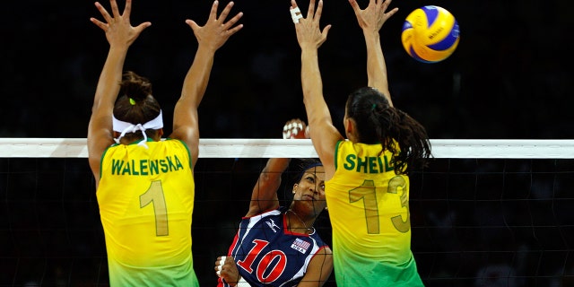Kim Glass, #10 of the United States, spikes a shot past Walewska Oliveira, #1, and Shiella Castro, #13 of Brazil, during the women's gold medal volleyball game held at the Beijing Institute of Technology Gymnasium on Day 15 of the Beijing 2008 Olympic Games on August 23, 2008 in Beijing, China.
