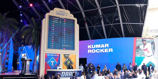 MLB Commissioner Rob Manfred, left, announces the selection of Kumar Rocker by the Texas Rangers with the third pick of the 2022 MLB baseball draft, Sunday, July 17, 2022, in Los Angeles.