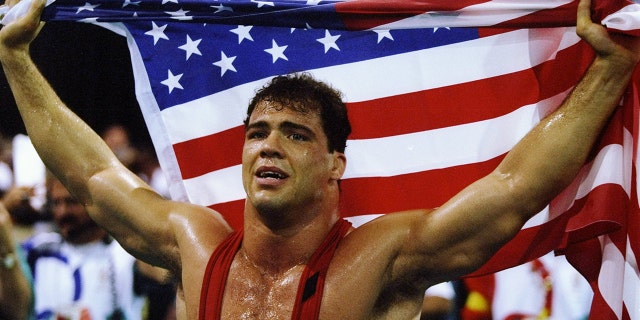 Kurt Angle of the United States holds the American flag at the free-style wrestling competition during the Summer Olympics at the Georgia World Congress Center in Atlanta, Georgia.