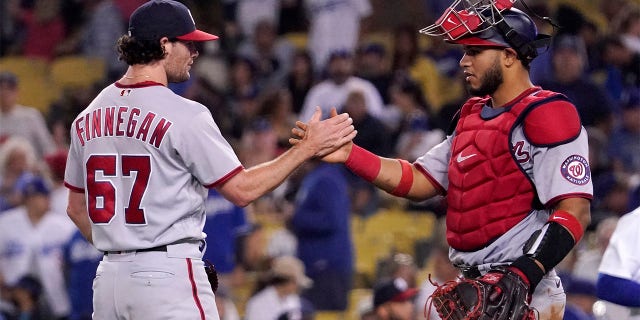 Washington Nationals relief pitcher Kyle Finnegan, left, and catcher Keibert Ruiz congratulate each other after the Nationals defeated the Los Angeles Dodgers 4-1 in a baseball game Monday, July 25, 2022, in Los Angeles.