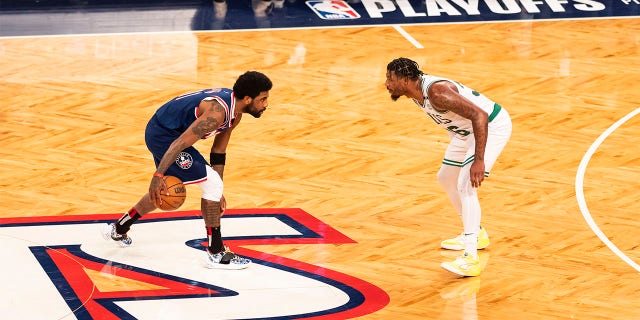 Kyrie Irving #11 of the Brooklyn Nets handles the ball against Marcus Smart #36 of the Boston Celtics during Round 1 Game 4 of the NBA Playoffs on April 25, 2022 at the Barclays Center in Brooklyn, New York. 