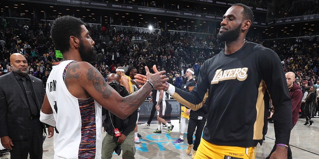 Kyrie Irving, left, of the Brooklyn Nets and LeBron James of the Los Angeles Lakers shake hands after a game Jan. 23, 2020, at Barclays Center in Brooklyn. 