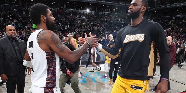 Kyrie Irving, left, of the Brooklyn Nets and LeBron James of the Los Angeles Lakers shake hands after a game Jan. 23, 2020, at Barclays Center in Brooklyn. 