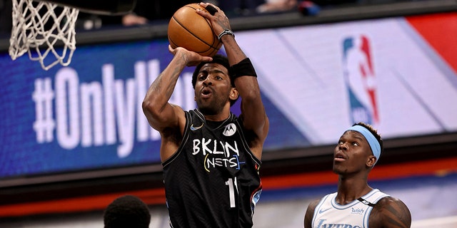 Kyrie Irving of the Brooklyn Nets takes a shot against the Los Angeles Lakes at Barclays Center on April 10, 2021 in New York City.