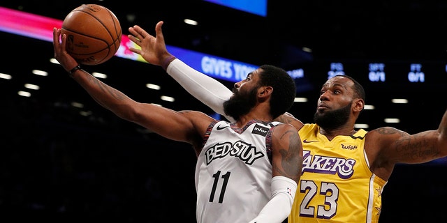 Kyrie Irving of the Brooklyn Nets in action against LeBron James of the Los Angeles Lakers at Barclays Center on Jan. 23, 2020, in New York City.