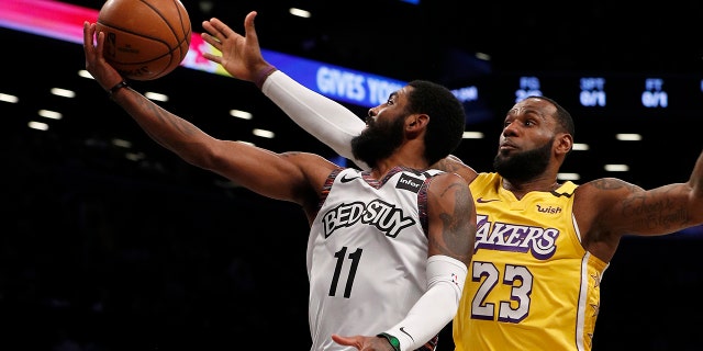 Kyrie Irving of the Brooklyn Nets in action against LeBron James of the Los Angeles Lakers at Barclays Center on Jan. 23, 2020, in New York City.