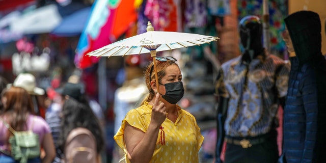 Shoppers in masks and without masks in a very congested market Santee Alley on Thursday, July 14, 2022 in Los Angeles, CA.