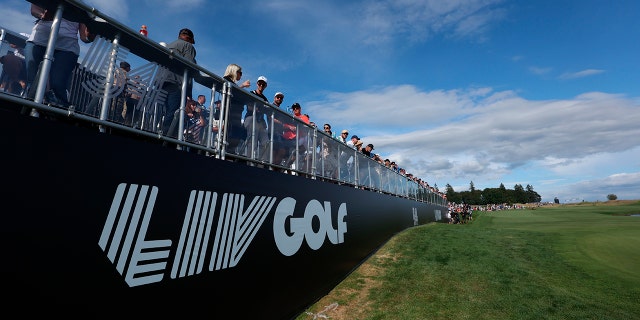 Fans await the final grouping at the 18th hole during the third round of the Portland Invitational LIV Golf tournament in North Plains, Ore., Saturday, July 2, 2022.