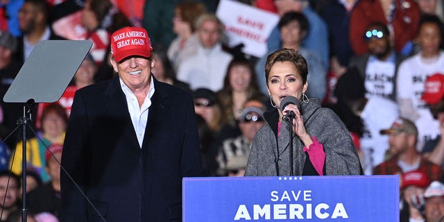 US-POLITICS-TRUMP-RALLY Former US President Donald Trump and Kari Lake, speak during a rally at the Canyon Moon Ranch festival grounds in Florence, Arizona, southeast of Phoenix, on January 15, 2022. 