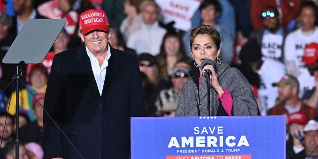 US-POLITICS-TRUMP-RALLY Former US President Donald Trump and Kari Lake, speak during a rally at the Canyon Moon Ranch festival grounds in Florence, Arizona, southeast of Phoenix, on January 15, 2022. 