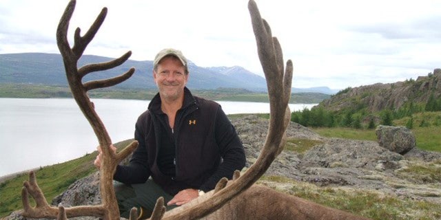 Lawrence Rudolph posing with an elk