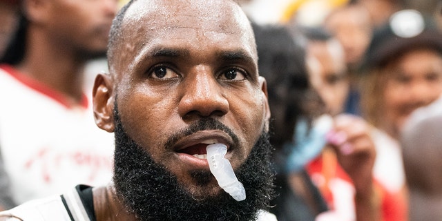 LeBron James sits during a timeout at the Drew League pro-am July 16, 2022, in Los Angeles.