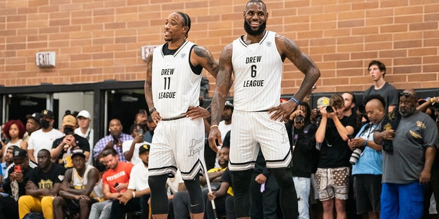 DeMar DeRozan and LeBron James smile on the court during the Drew League pro-am July 16, 2022, in Los Angeles.