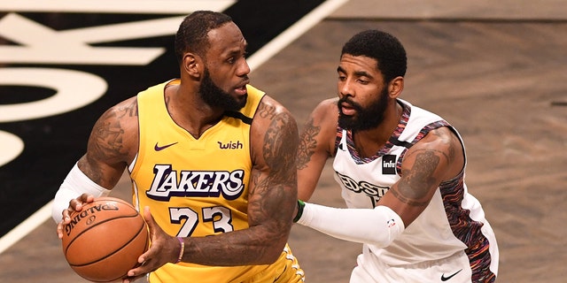 LeBron James (23) of the Los Angeles Lakers in action against Kyrie Irving (11) during a game against the Brooklyn Nets at Barclays Center Jan. 23, 2020, in New York City.