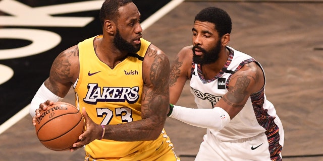 LeBron James (23) of the Los Angeles Lakers in action against Kyrie Irving (11) during a game against the Brooklyn Nets at Barclays Center Jan. 23, 2020, in New York City.