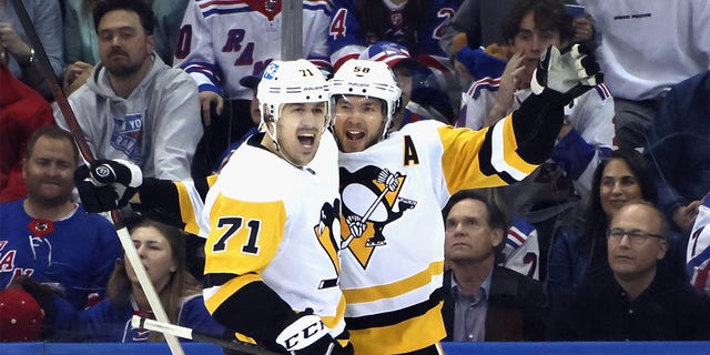 Chris Letang and Evgeni Malkin of the Pittsburgh Penguins celebrate a second-period goal against the New York Rangers during the Stanley Cup playoffs at Madison Square Garden on May 11, 2022. 